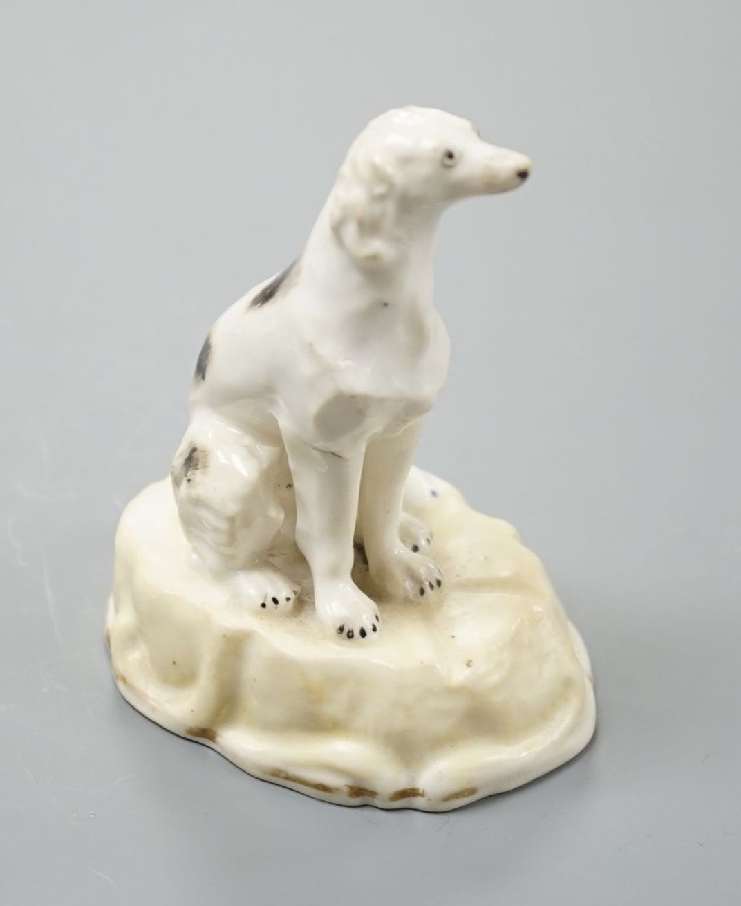 A rare Samuel Alcock porcelain model of a saluki or Persian greyhound, impressed mark 252, 8.3 cm high, Cf. Dennis G.Rice Dogs in English porcelain, colour plate 214 illustrating an identical example with incorrect facto